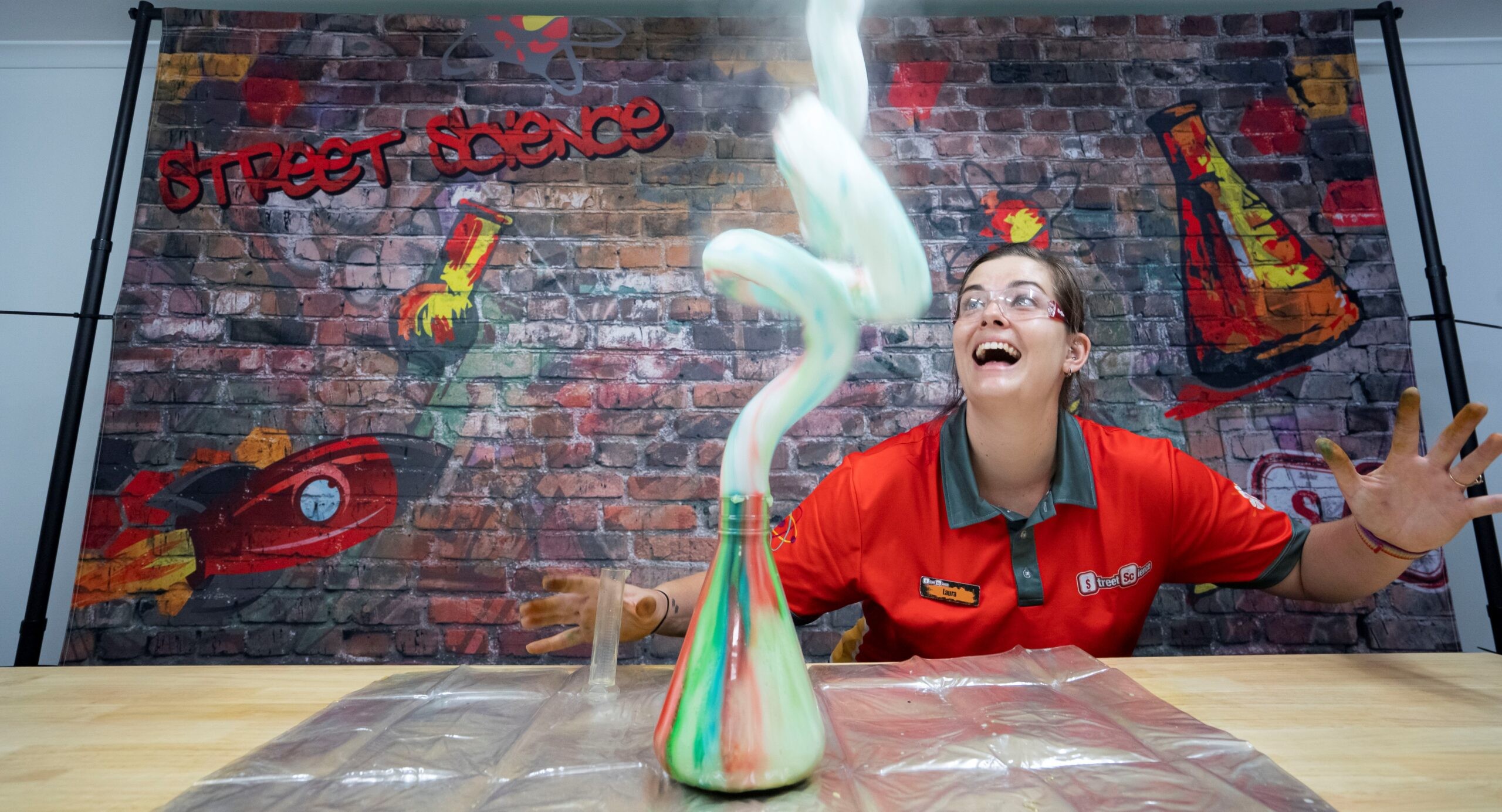 Scientist with elephant toothpaste foam squirting out of a glass beaker | Street Science