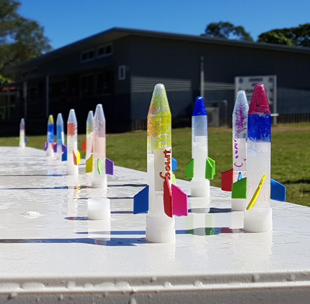 Homemade bottle rockets on a table outside | Street Science