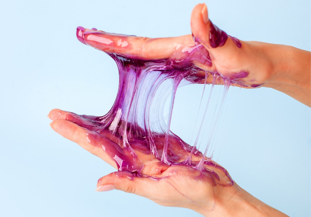 Sticky purple gel stretched between two hands | Street Science